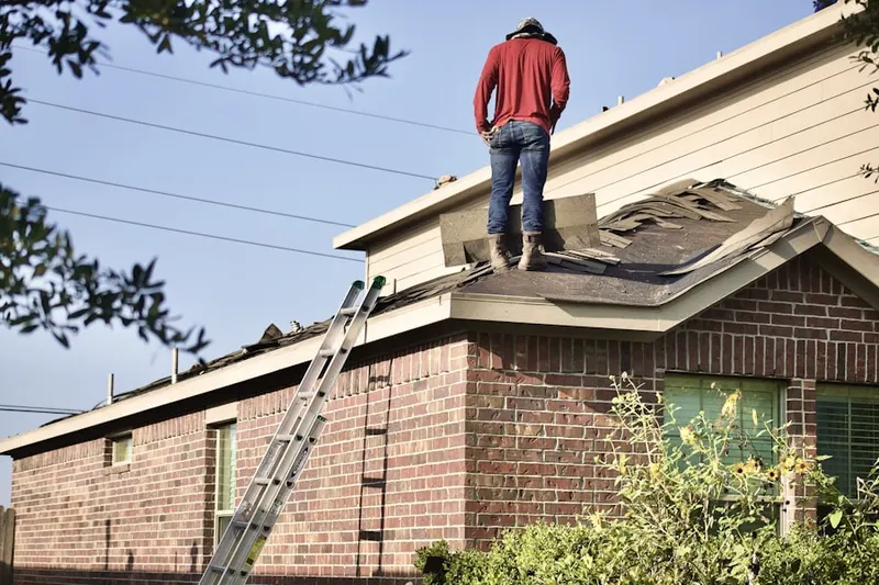 Professional roofer working on a residential roof in Woodbine Junction